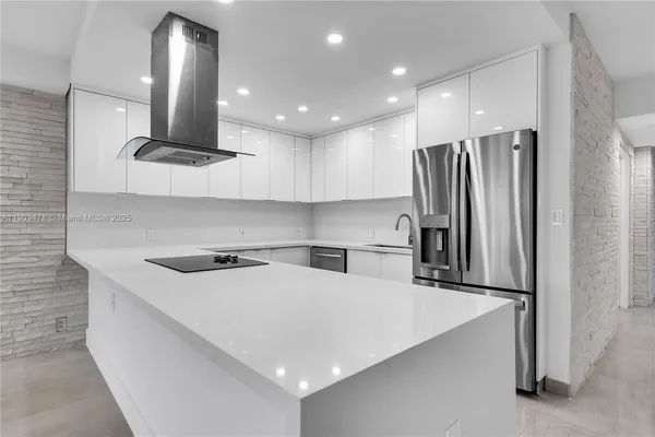 a kitchen with stainless steel appliances a refrigerator sink and microwave