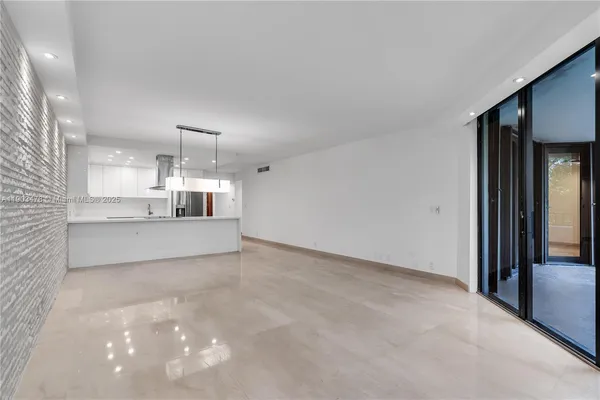 a view of a kitchen with a sink and a refrigerator