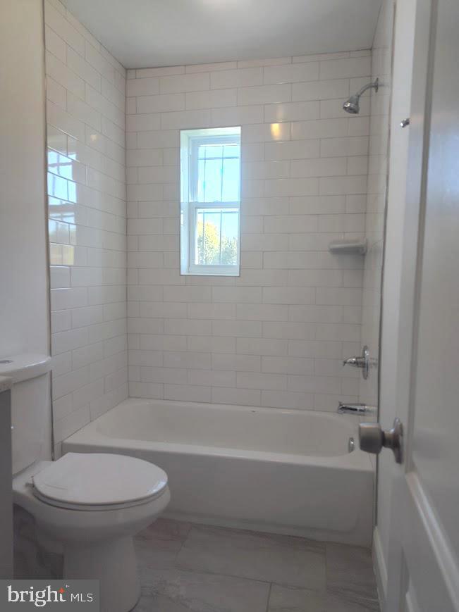 4230 6th Street Southeast, Unit 3 Washington, DC 20032 - Photo 4 of 25 a bathroom with a toilet and a bath tub