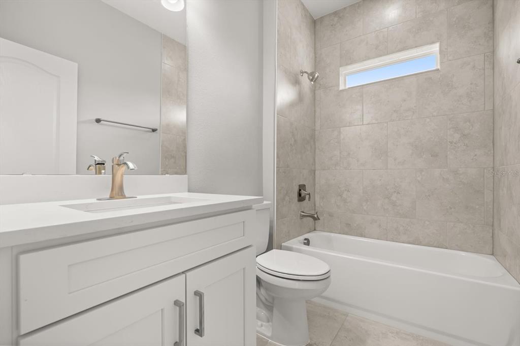0 Marion Oaks Manor Ocala, FL 34473 - Photo 22 of 24 a bathroom with a toilet a sink a mirror and bathtub