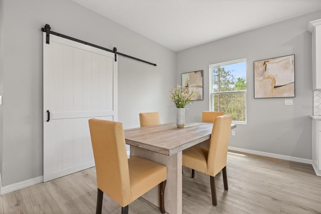 0 Marion Oaks Manor Ocala, FL 34473 - Photo 4 of 24 a view of a dining room with furniture and wooden floor