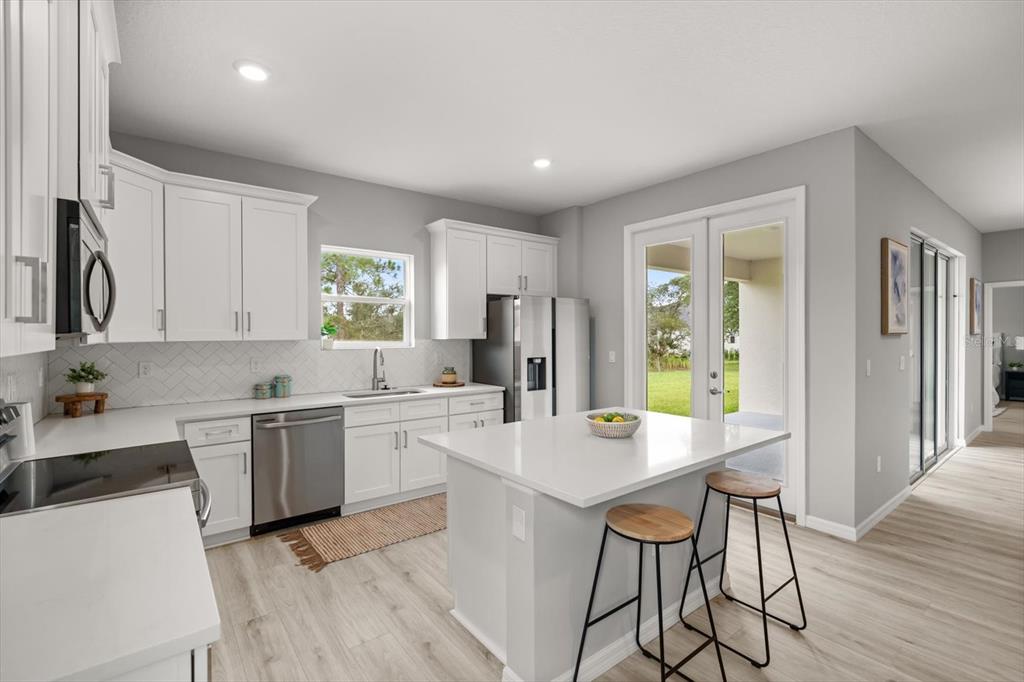 0 Marion Oaks Manor Ocala, FL 34473 - Photo 7 of 24 a kitchen with a dining table chairs and refrigerator