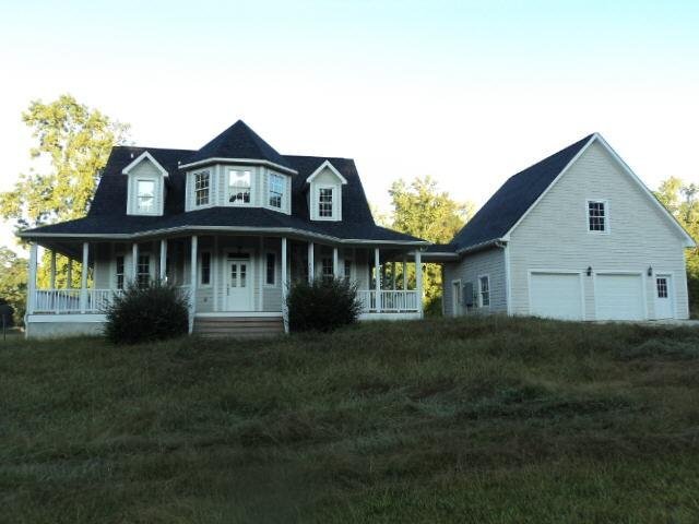174 Huckaby Road Brooks, GA 30205 - Photo 1 of 1 a front view of a house with a garden