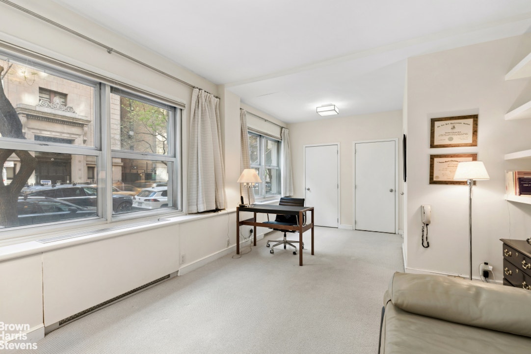 35 East 85th Street, Unit OF3S Manhattan, NY 10028 - Photo 4 of 9 a living room with furniture and a large window