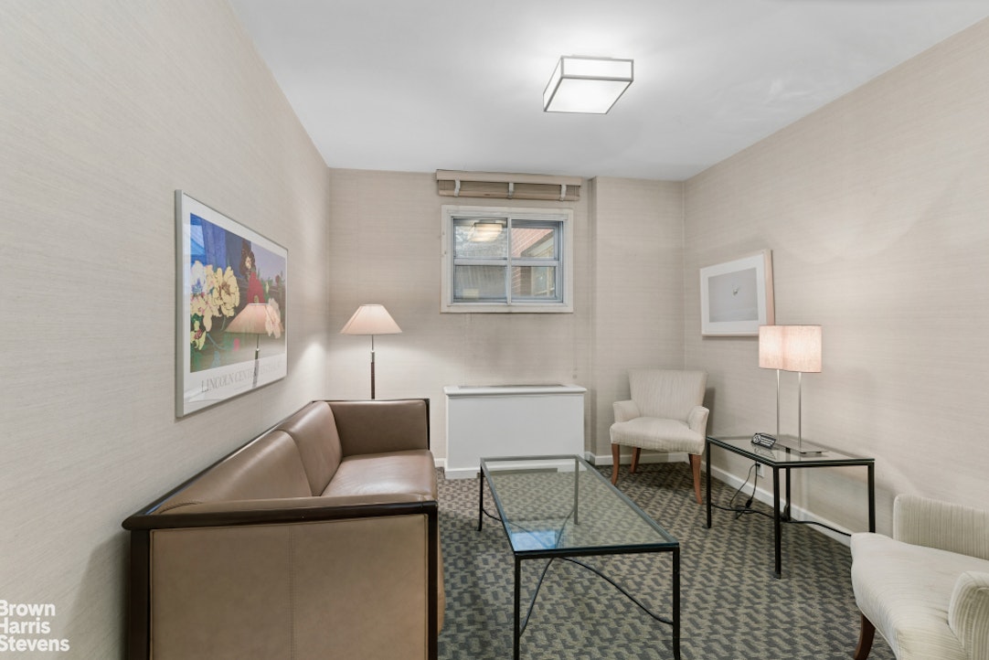 35 East 85th Street, Unit OF3S Manhattan, NY 10028 - Photo 7 of 9 a living room with furniture and a lamp