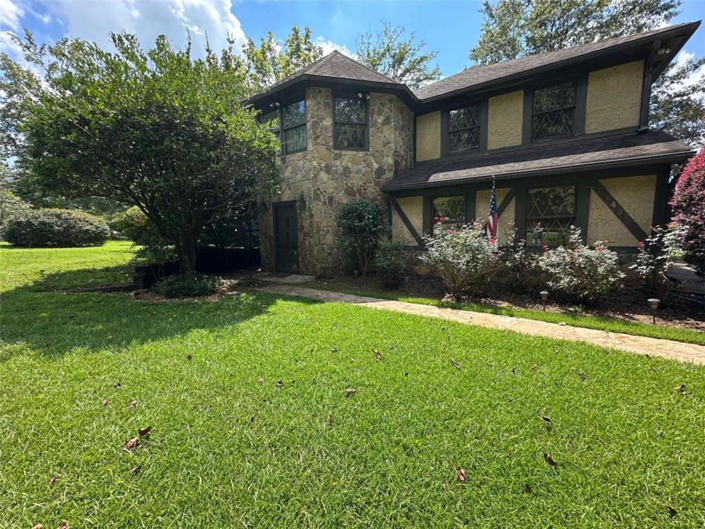 a front view of a house with garden