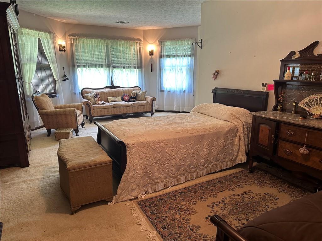 2145 Hampton Trail Southeast Conyers, GA 30013 - Photo 13 of 20 a bedroom with a bed and large window