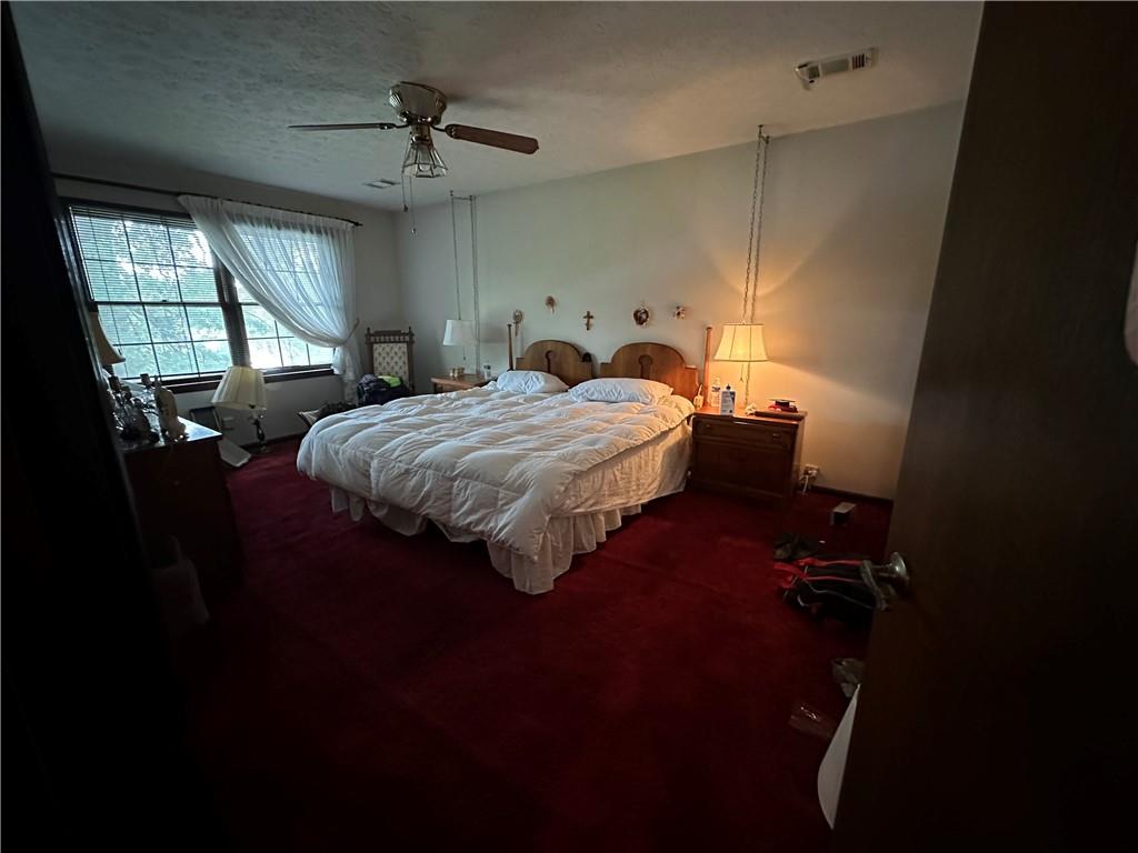 2145 Hampton Trail Southeast Conyers, GA 30013 - Photo 14 of 20 a bed room with a bed and a chandelier