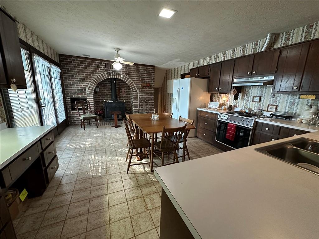 2145 Hampton Trail Southeast Conyers, GA 30013 - Photo 15 of 20 a kitchen with stainless steel appliances a sink a stove a refrigerator cabinets and dining table