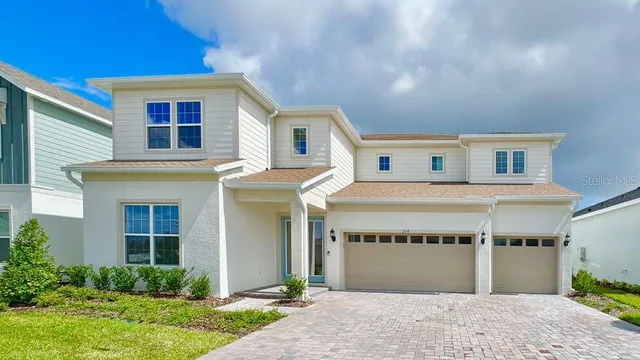 a view of a house with a yard and garage