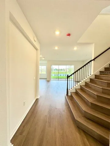 a view of entryway and hall with wooden floor