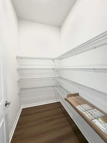 a view of a room with wooden floor