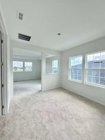 an empty room with windows and entrance