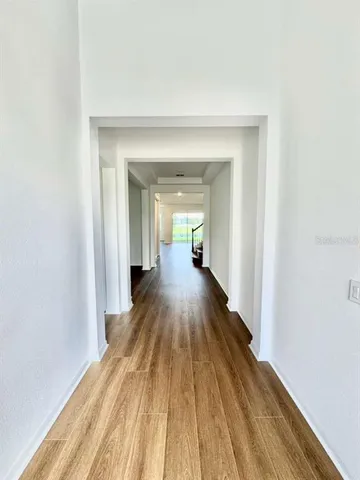 a view of a room with wooden floor