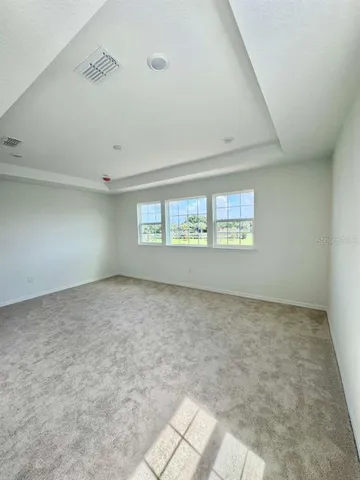 an empty room with a empty space and windows