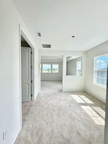 an empty room with windows and closet