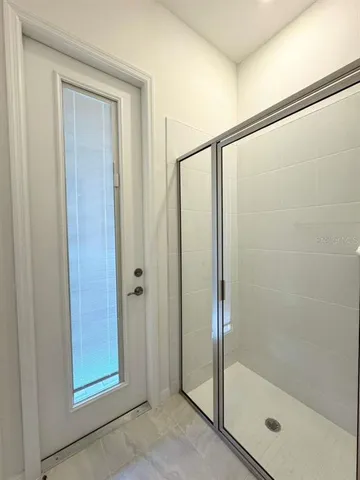 a bathroom with a glass shower door