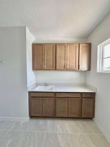 a kitchen with a cabinets and window