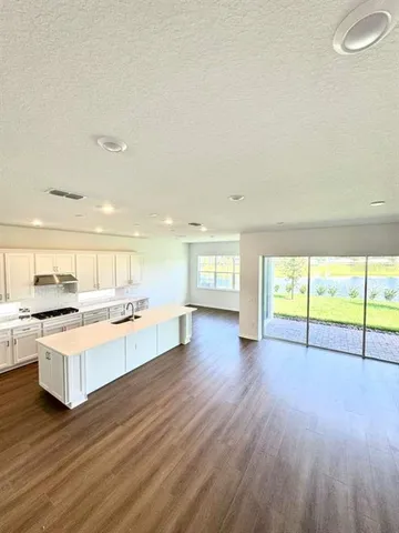 a large kitchen with lot of wooden floor