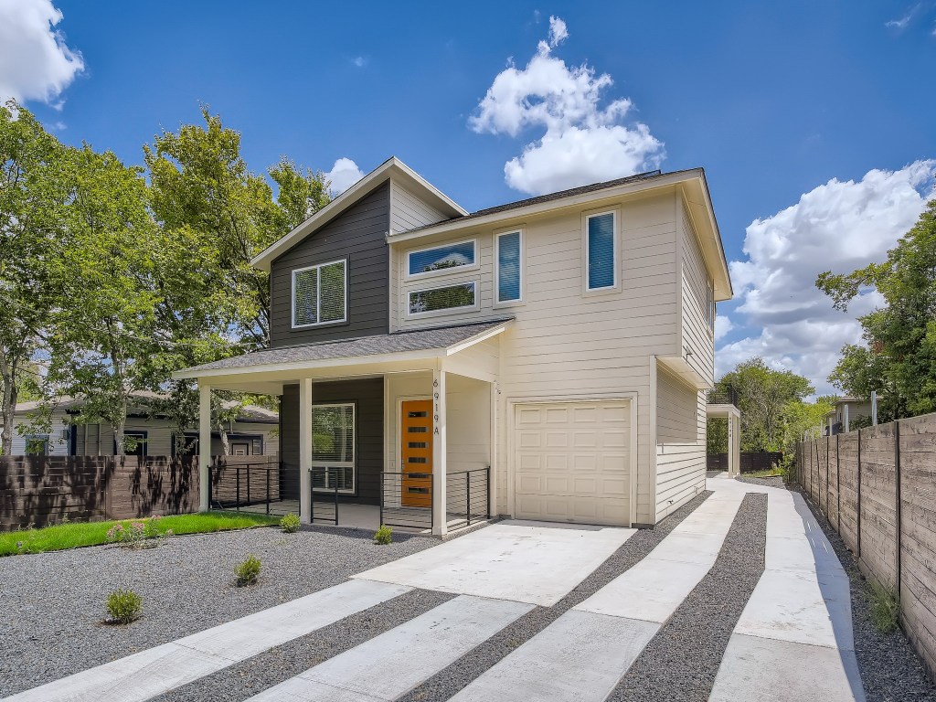 Modern home with a porch, concrete driveway, and a garage