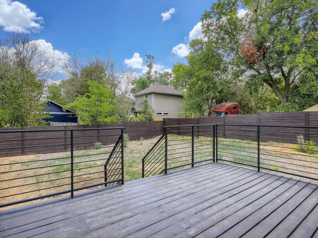 6919 Bethune Avenue, Unit B Austin, TX 78752 - Photo 5 of 6 Wooden deck with a fenced backyard and view of scattered trees