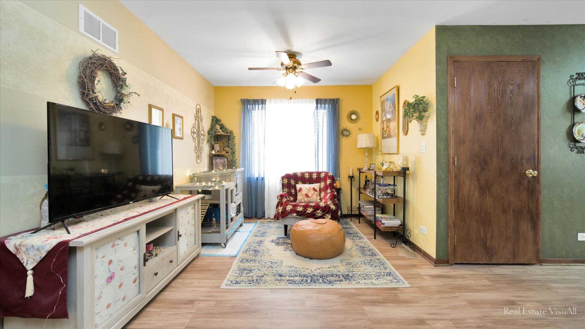 510 Timber Drive Harvard, IL 60033 - Photo 5 of 18 a living room with a flat screen tv and a chandelier
