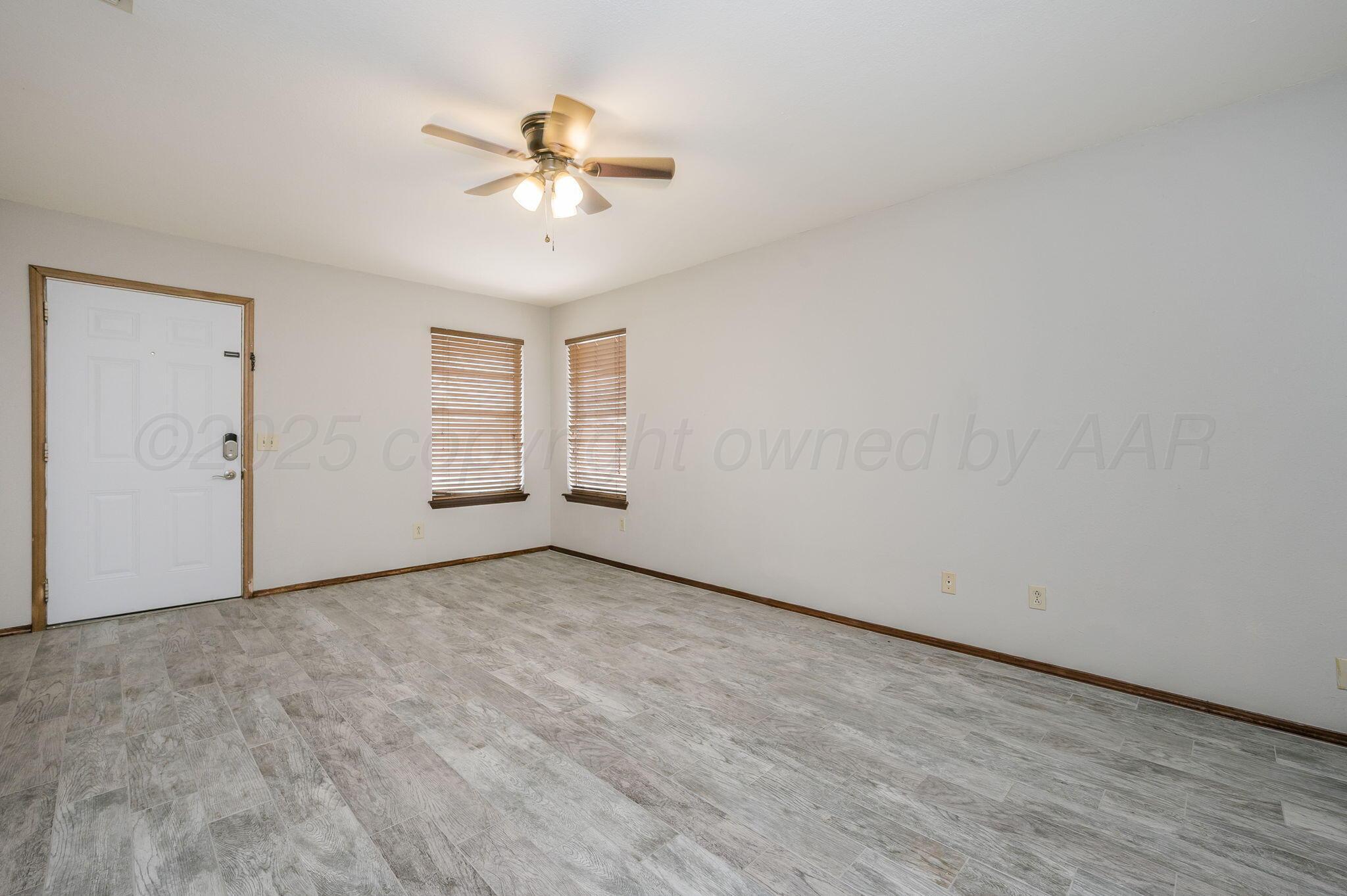 1624 Lockney Street Amarillo, TX 79106 - Photo 2 of 16 an empty room with fan and windows
