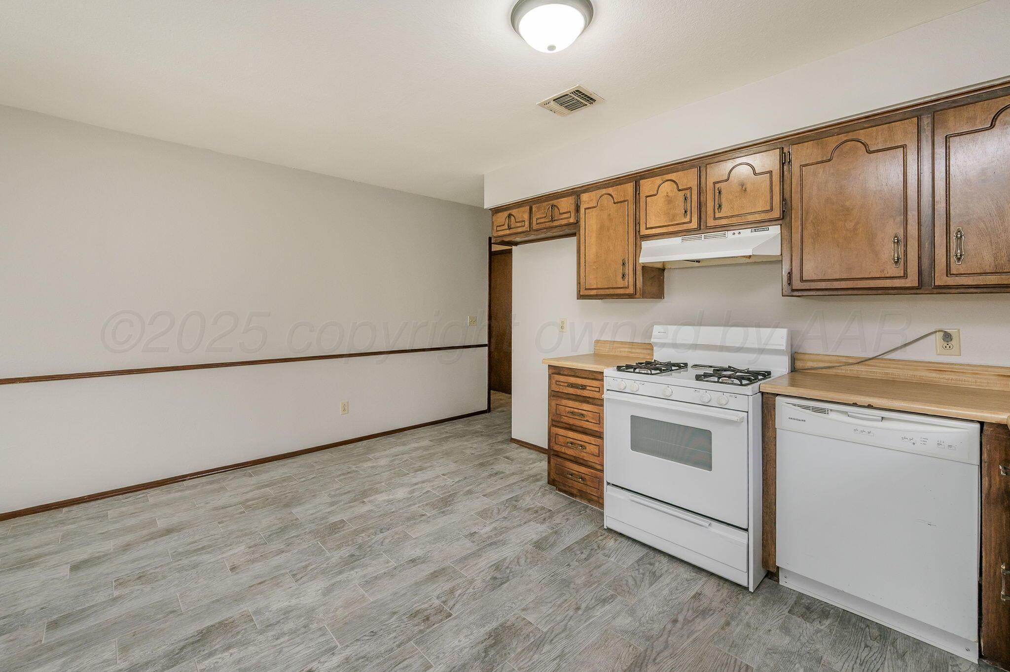 1624 Lockney Street Amarillo, TX 79106 - Photo 5 of 16 a kitchen with stainless steel appliances granite countertop a stove and a sink