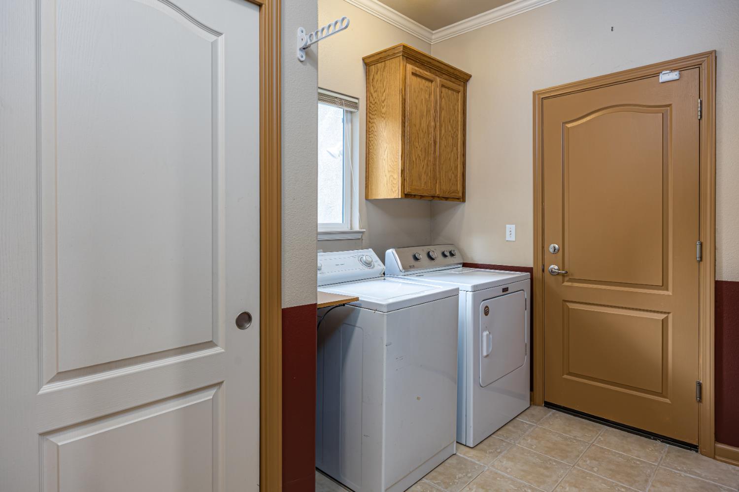 2083 State Rte 26 Valley Springs, CA 95252 - Photo 28 of 59 a utility room with cabinets washer and dryer