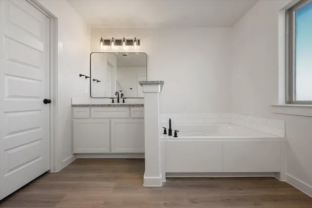 a bathroom with a bathtub and a sink