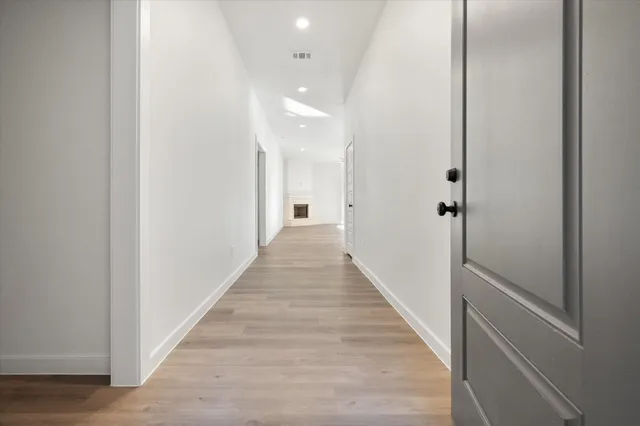 a view of a hallway with wooden floor
