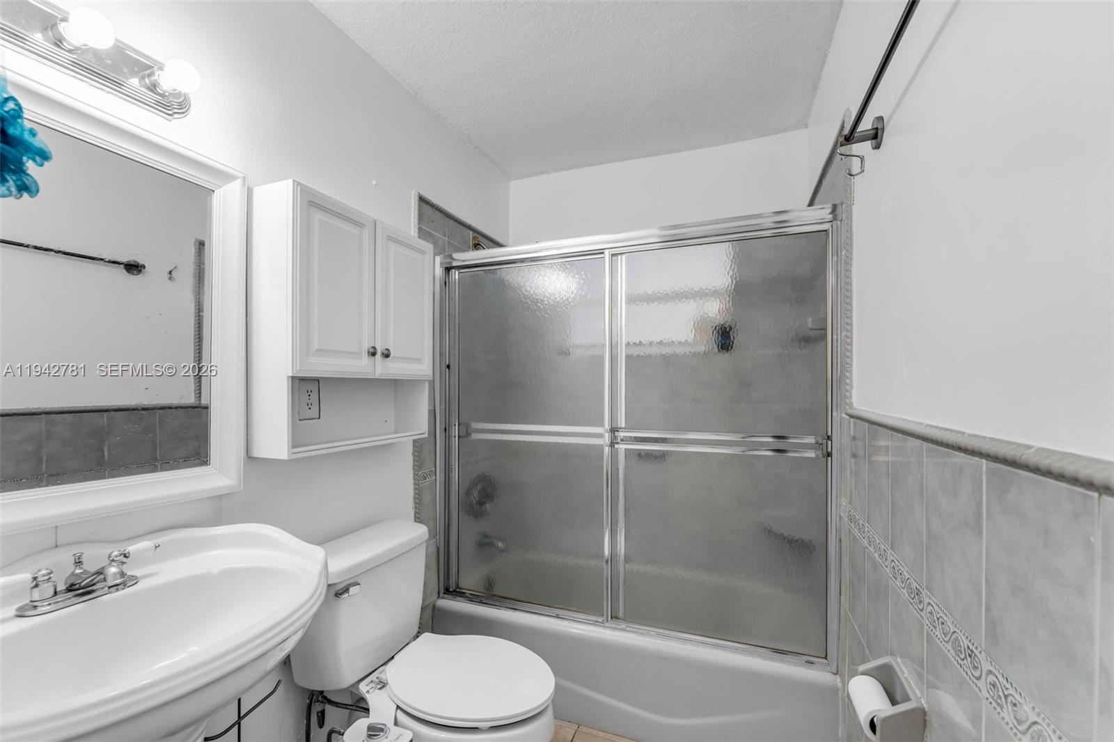 15805 Southwest 300th Terrace Homestead, FL 33033 - Photo 20 of 52 a bathroom with a shower sink vanity mirror and toilet