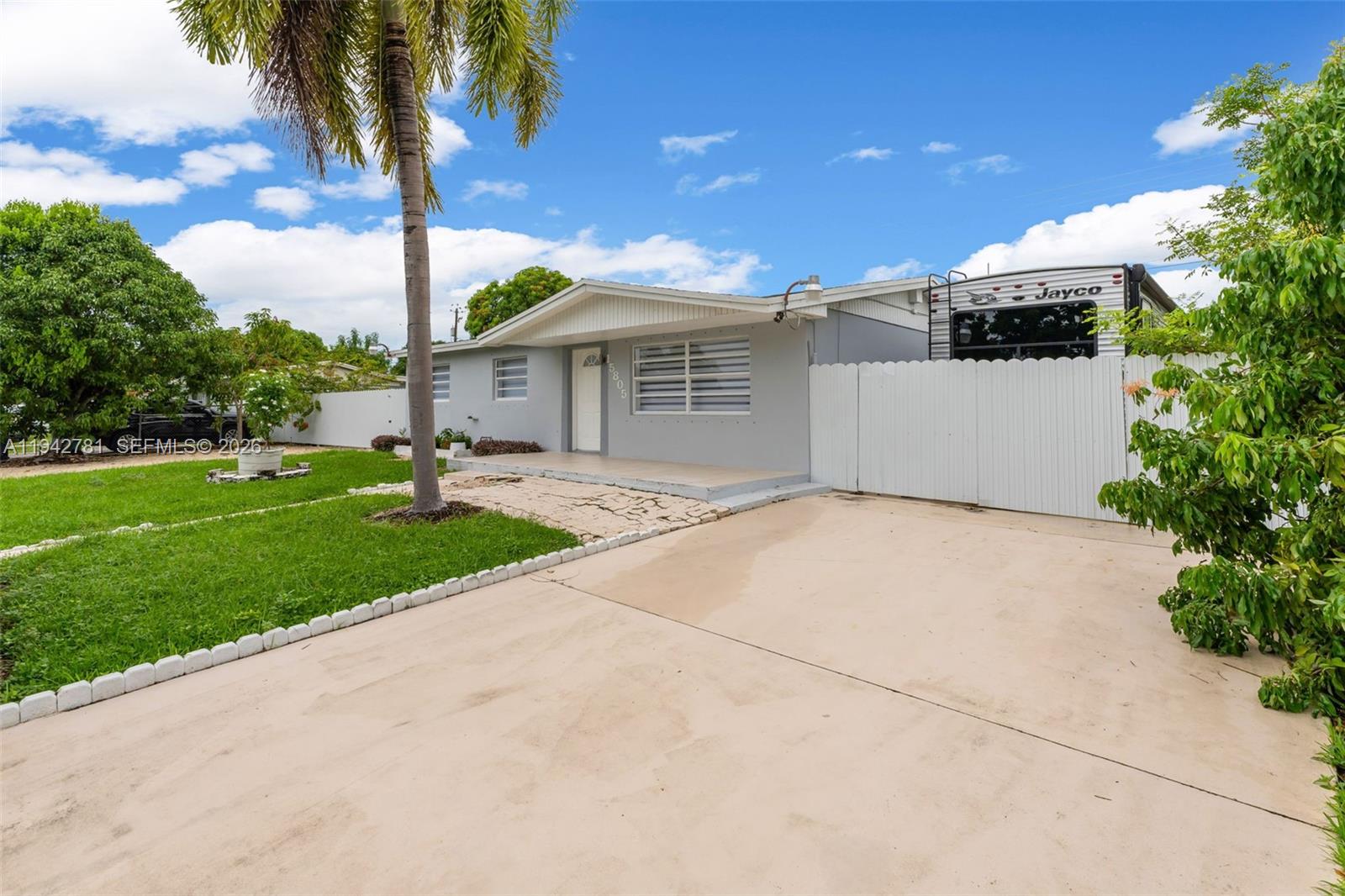 15805 Southwest 300th Terrace Homestead, FL 33033 - Photo 3 of 52 a front view of a house with a yard and garage
