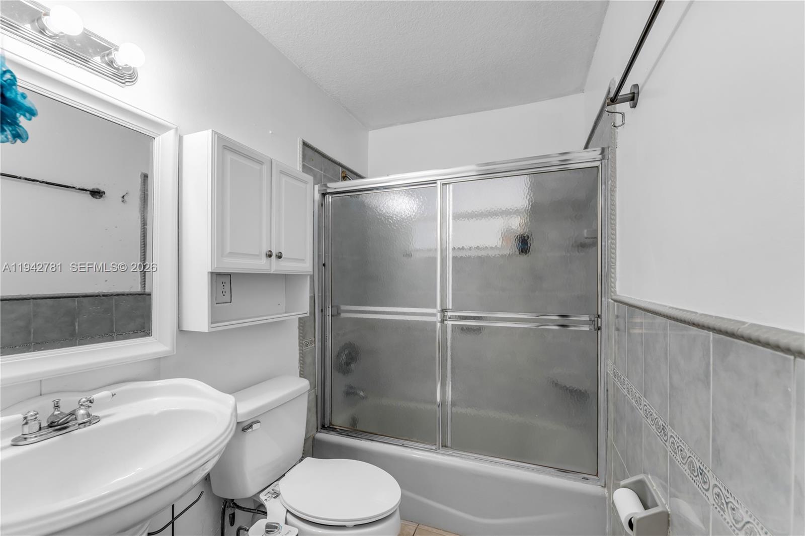 15805 Southwest 300th Terrace Homestead, FL 33033 - Photo 36 of 52 a bathroom with a shower sink vanity mirror and toilet