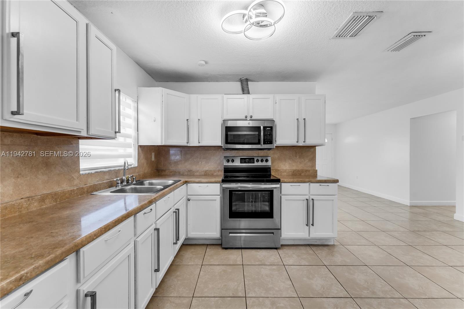 15805 Southwest 300th Terrace Homestead, FL 33033 - Photo 39 of 52 a kitchen with cabinets appliances and a sink