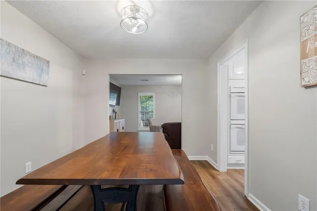 a view of a big room with wooden floor windows and chandelier