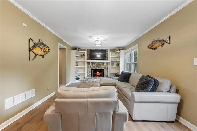 a living room with furniture a fireplace and a flat screen tv