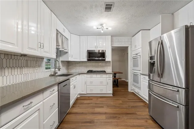 a kitchen with a refrigerator and a sink