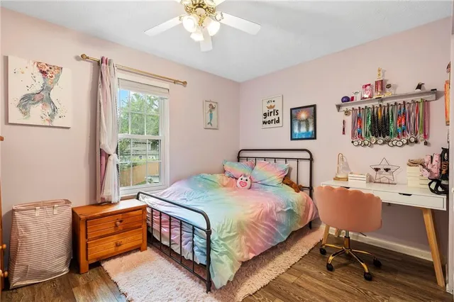 a bedroom that has a bed and a dresser in it