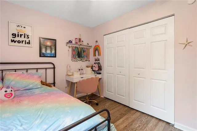 a bedroom with a bed and a dresser in it