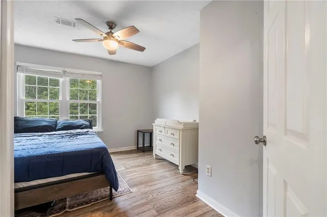 a view of a big house with a big yard and large trees