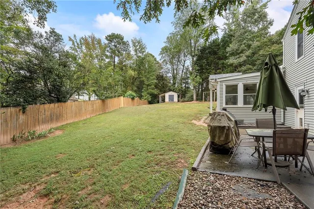 a view of a house with a yard and sitting area