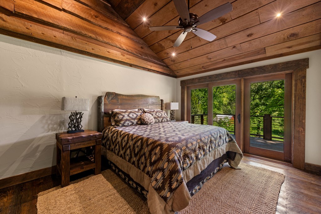 2100 Big Creek Road Cherry Log, GA 30522 - Photo 111 of 148 a bed sitting in a spacious bedroom next to a window