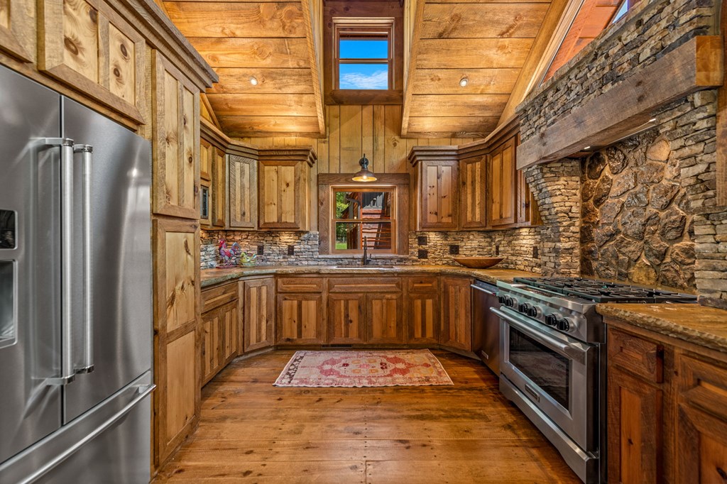 2100 Big Creek Road Cherry Log, GA 30522 - Photo 10 of 148 a kitchen with stainless steel appliances granite countertop a stove a sink and dishwasher