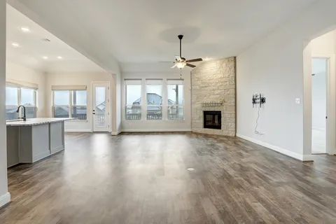an empty room with wooden floor and outdoor view