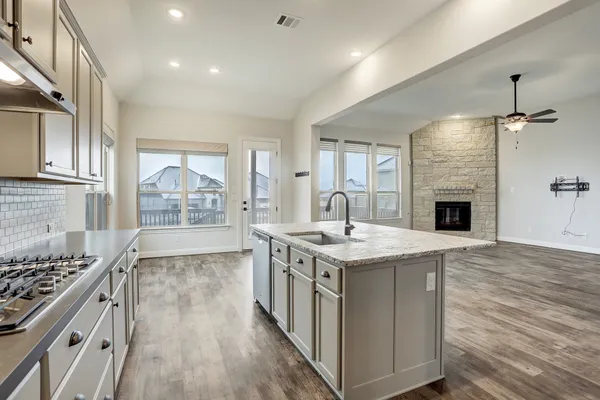 a kitchen with a stove and a sink