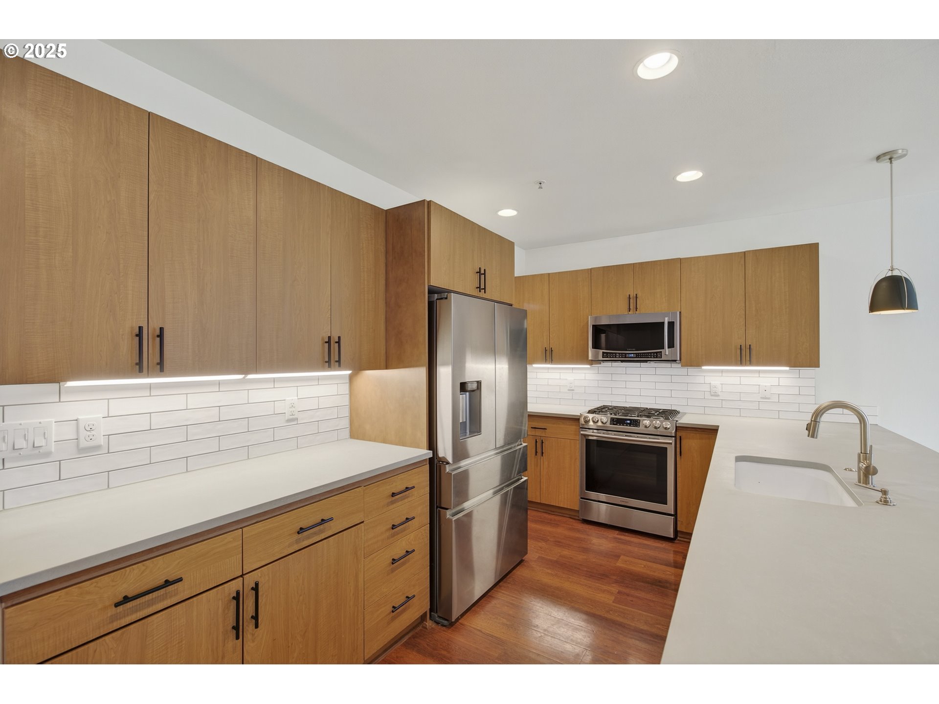 8083 North Leavitt Avenue Portland, OR 97203 - Photo 11 of 34 a kitchen with stainless steel appliances granite countertop a sink a stove a refrigerator cabinets and a counter top space