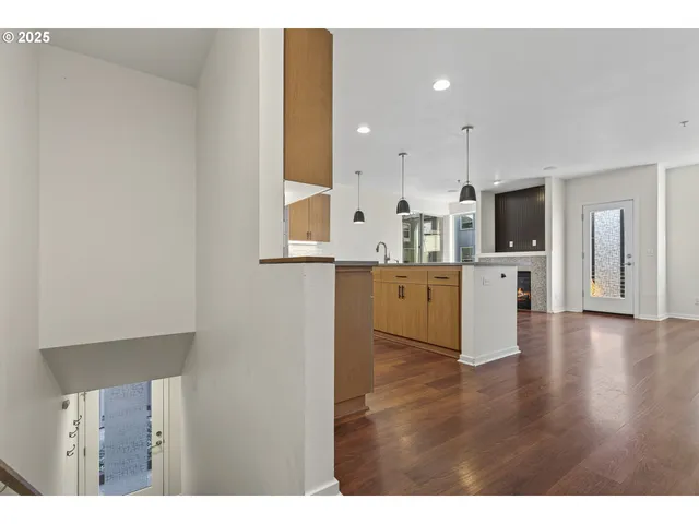 a view of a kitchen with a sink stove cabinets and entryway