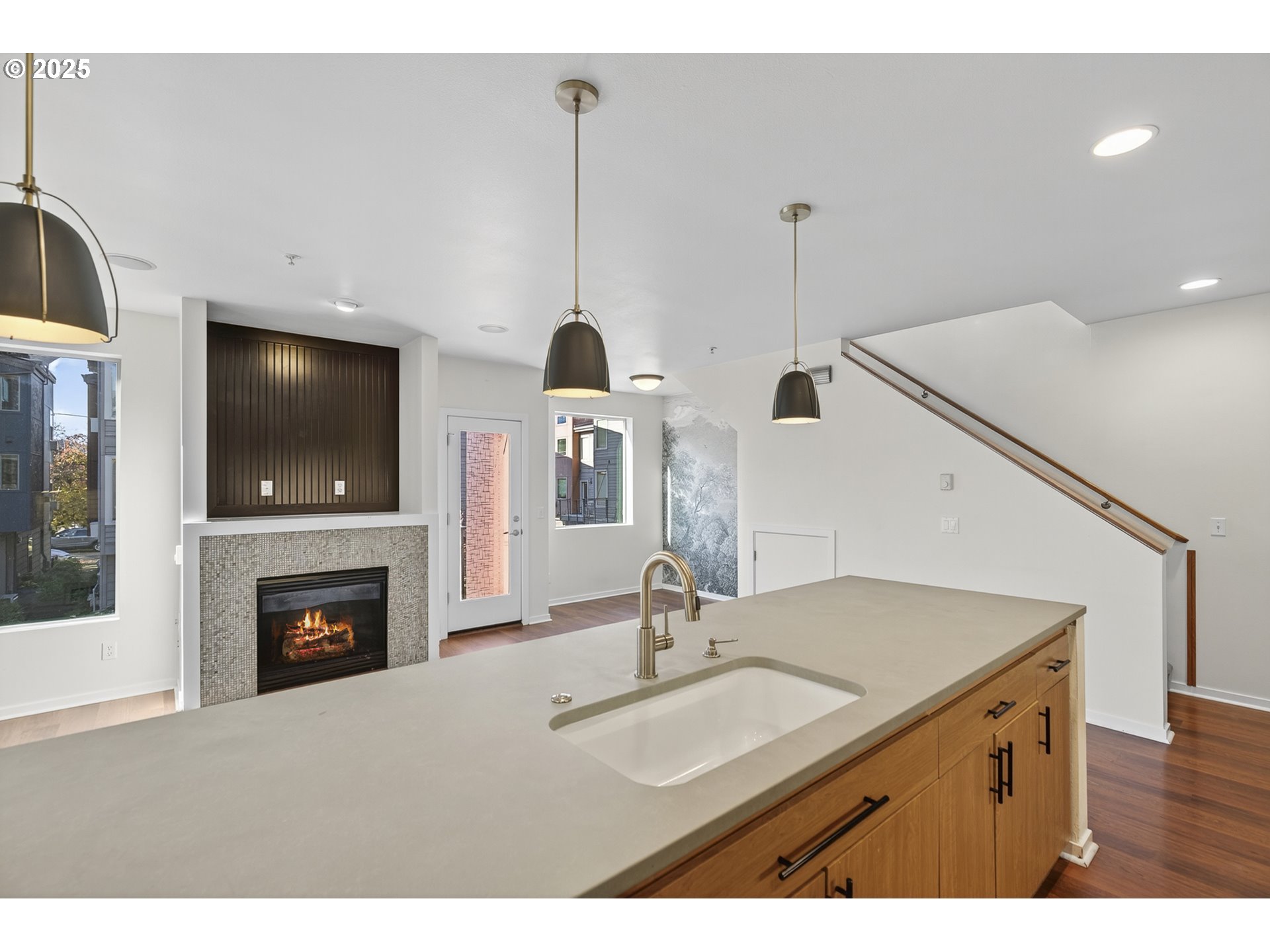 8083 North Leavitt Avenue Portland, OR 97203 - Photo 13 of 34 a kitchen with a sink a fireplace and a flat screen tv
