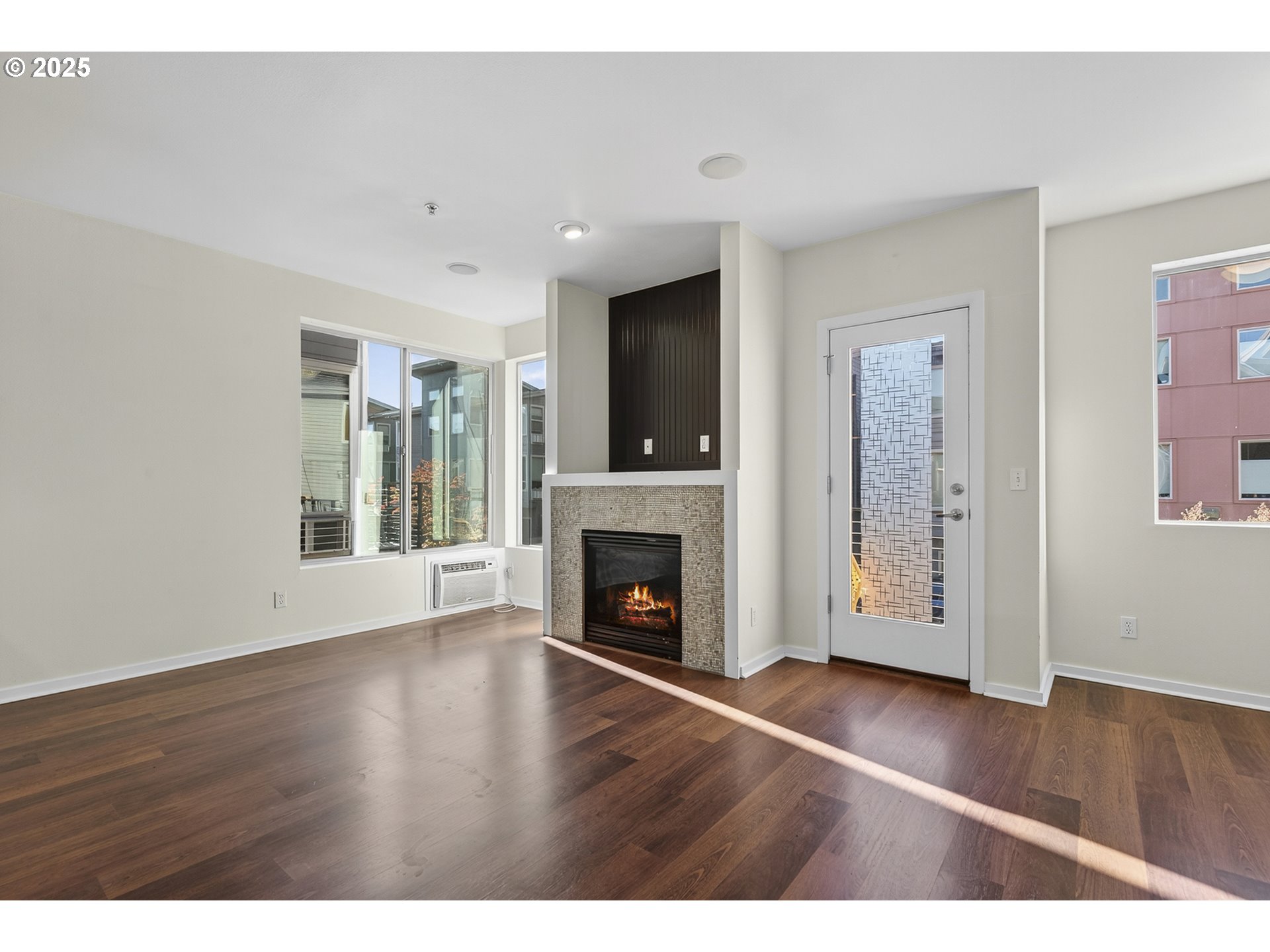8083 North Leavitt Avenue Portland, OR 97203 - Photo 14 of 34 a view of an empty room with wooden floor fireplace and a window